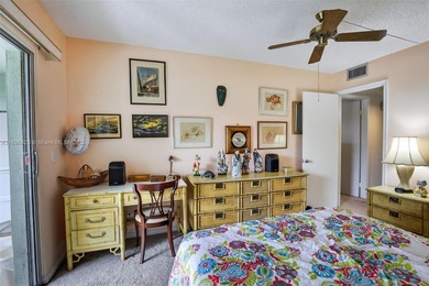 Enjoy serene lake and golf course views from this first-floor on Flamingo Lakes Country Club in Florida - for sale on GolfHomes.com, golf home, golf lot