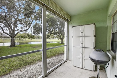 Enjoy serene lake and golf course views from this first-floor on Flamingo Lakes Country Club in Florida - for sale on GolfHomes.com, golf home, golf lot