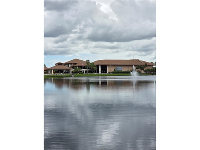 Enjoy serene lake and golf course views from this first-floor on Flamingo Lakes Country Club in Florida - for sale on GolfHomes.com, golf home, golf lot
