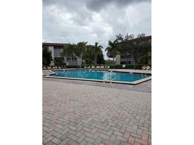 Enjoy serene lake and golf course views from this first-floor on Flamingo Lakes Country Club in Florida - for sale on GolfHomes.com, golf home, golf lot
