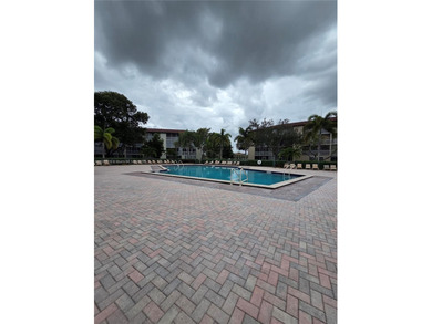 Enjoy serene lake and golf course views from this first-floor on Flamingo Lakes Country Club in Florida - for sale on GolfHomes.com, golf home, golf lot