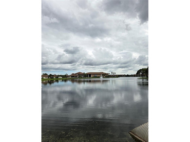 Enjoy serene lake and golf course views from this first-floor on Flamingo Lakes Country Club in Florida - for sale on GolfHomes.com, golf home, golf lot