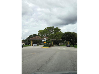 Enjoy serene lake and golf course views from this first-floor on Flamingo Lakes Country Club in Florida - for sale on GolfHomes.com, golf home, golf lot