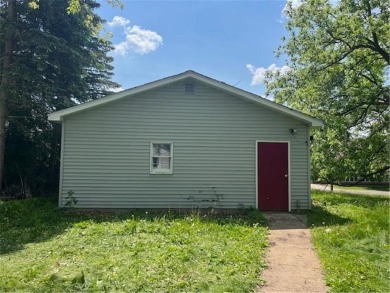 In the heart of town, this 2 story is nestled in between mature on The Amery Golf Club in Wisconsin - for sale on GolfHomes.com, golf home, golf lot