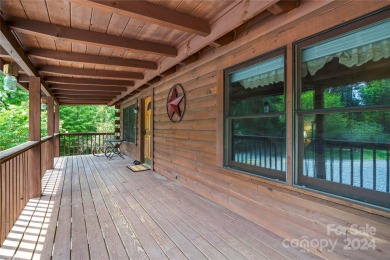 Welcome to your dream cabin nestled in the highly sought-after on Rumbling Bald Resort on Lake Lure in North Carolina - for sale on GolfHomes.com, golf home, golf lot