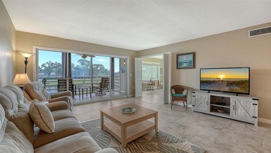 Rarely available 3-bedroom end unit featuring sweeping golf on Palm Aire Country Club of Sarasota in Florida - for sale on GolfHomes.com, golf home, golf lot