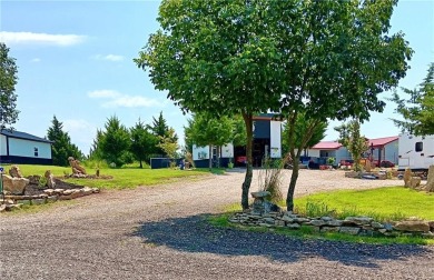 Welcome to your idyllic retreat at 14 Pinehurst Drive in serene on Linn Valley Lakes - Deer Trace Golf Course in Kansas - for sale on GolfHomes.com, golf home, golf lot