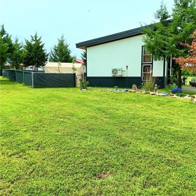 Welcome to your idyllic retreat at 14 Pinehurst Drive in serene on Linn Valley Lakes - Deer Trace Golf Course in Kansas - for sale on GolfHomes.com, golf home, golf lot