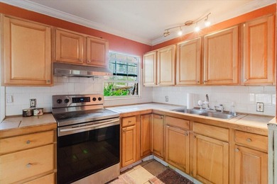 Tucked beneath the shade of mature trees in the beloved Edgemoor on Mangrove Bay Golf Course in Florida - for sale on GolfHomes.com, golf home, golf lot