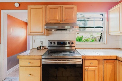 Tucked beneath the shade of mature trees in the beloved Edgemoor on Mangrove Bay Golf Course in Florida - for sale on GolfHomes.com, golf home, golf lot