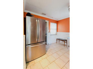 Tucked beneath the shade of mature trees in the beloved Edgemoor on Mangrove Bay Golf Course in Florida - for sale on GolfHomes.com, golf home, golf lot