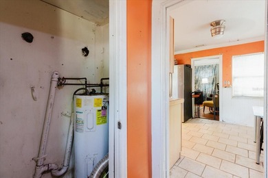 Tucked beneath the shade of mature trees in the beloved Edgemoor on Mangrove Bay Golf Course in Florida - for sale on GolfHomes.com, golf home, golf lot