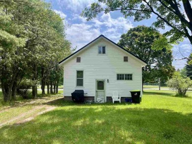 Cottage style home on Residential / Commercial lot. Located next on Charlevoix Golf Club in Michigan - for sale on GolfHomes.com, golf home, golf lot
