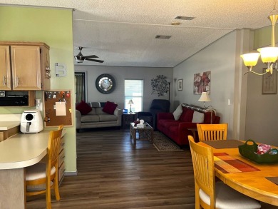 Experience comfortable living in this beautifully updated on Lake Henry Golf Club in Florida - for sale on GolfHomes.com, golf home, golf lot