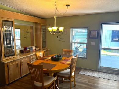Experience comfortable living in this beautifully updated on Lake Henry Golf Club in Florida - for sale on GolfHomes.com, golf home, golf lot