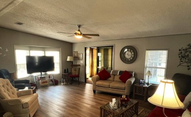 Experience comfortable living in this beautifully updated on Lake Henry Golf Club in Florida - for sale on GolfHomes.com, golf home, golf lot