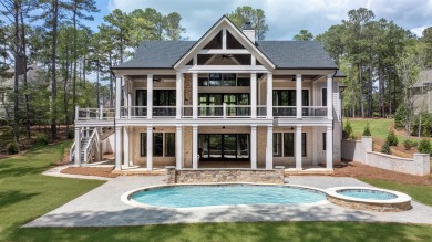 Indulge in opulent living within this custom 5-bedroom, 5.5-bath on Reynolds Lake Oconee - The Oconee in Georgia - for sale on GolfHomes.com, golf home, golf lot
