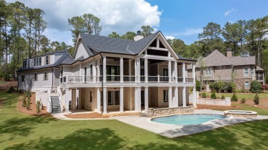 Indulge in opulent living within this custom 5-bedroom, 5.5-bath on Reynolds Lake Oconee - The Oconee in Georgia - for sale on GolfHomes.com, golf home, golf lot