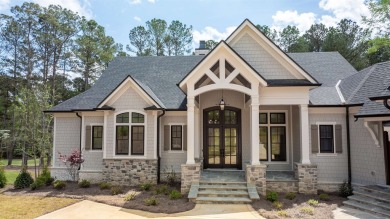 Indulge in opulent living within this custom 5-bedroom, 5.5-bath on Reynolds Lake Oconee - The Oconee in Georgia - for sale on GolfHomes.com, golf home, golf lot