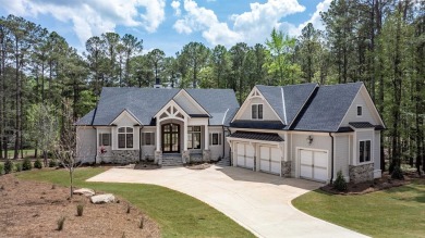 Indulge in opulent living within this custom 5-bedroom, 5.5-bath on Reynolds Lake Oconee - The Oconee in Georgia - for sale on GolfHomes.com, golf home, golf lot