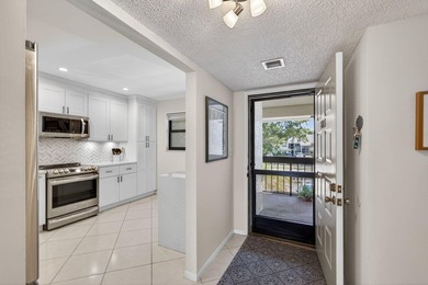 Beautifully updated 2-bedroom, 2-bath second-floor condo on Old Marsh Golf Club in Florida - for sale on GolfHomes.com, golf home, golf lot