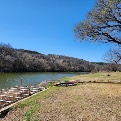 Immaculate riverfront home with a gradual slope yard to the on Pecan Plantation Country Club in Texas - for sale on GolfHomes.com, golf home, golf lot