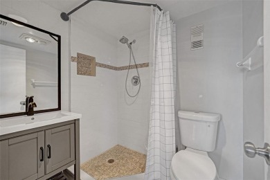 Experience resort-style living in this spacious 2-bedroom on Pine Island Ridge Country Club in Florida - for sale on GolfHomes.com, golf home, golf lot