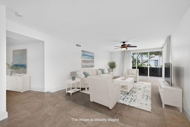 SPACIOUS FIRST FLOOR CORNER UNIT FILLED WITH NATURAL LIGHT on BallenIsles Golf and Country Club in Florida - for sale on GolfHomes.com, golf home, golf lot