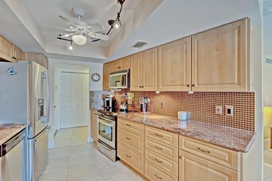 SPACIOUS FIRST FLOOR CORNER UNIT FILLED WITH NATURAL LIGHT on BallenIsles Golf and Country Club in Florida - for sale on GolfHomes.com, golf home, golf lot