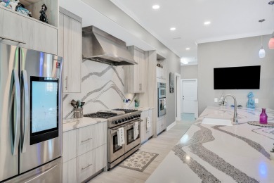 Tucked behind the private gates of the Bay Point community, this on Bay Point Resort Golf Club in Florida - for sale on GolfHomes.com, golf home, golf lot