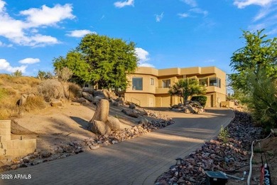 The Belgard pavers of the circular driveway lead up to this on Troon North Golf Club  in Arizona - for sale on GolfHomes.com, golf home, golf lot