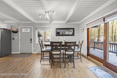 Tucked beneath a canopy of whispering trees, this modern chalet on Pocono Farms Country Club in Pennsylvania - for sale on GolfHomes.com, golf home, golf lot
