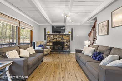 Tucked beneath a canopy of whispering trees, this modern chalet on Pocono Farms Country Club in Pennsylvania - for sale on GolfHomes.com, golf home, golf lot