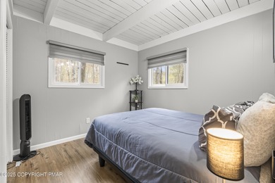 Tucked beneath a canopy of whispering trees, this modern chalet on Pocono Farms Country Club in Pennsylvania - for sale on GolfHomes.com, golf home, golf lot