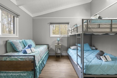 Tucked beneath a canopy of whispering trees, this modern chalet on Pocono Farms Country Club in Pennsylvania - for sale on GolfHomes.com, golf home, golf lot