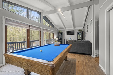 Tucked beneath a canopy of whispering trees, this modern chalet on Pocono Farms Country Club in Pennsylvania - for sale on GolfHomes.com, golf home, golf lot