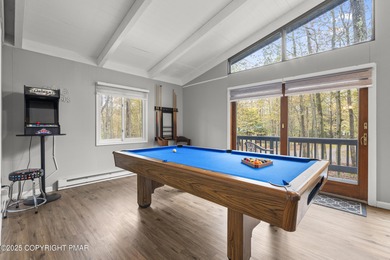 Tucked beneath a canopy of whispering trees, this modern chalet on Pocono Farms Country Club in Pennsylvania - for sale on GolfHomes.com, golf home, golf lot