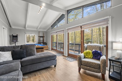Tucked beneath a canopy of whispering trees, this modern chalet on Pocono Farms Country Club in Pennsylvania - for sale on GolfHomes.com, golf home, golf lot