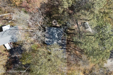 Tucked beneath a canopy of whispering trees, this modern chalet on Pocono Farms Country Club in Pennsylvania - for sale on GolfHomes.com, golf home, golf lot