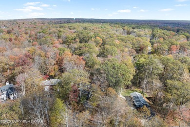 Tucked beneath a canopy of whispering trees, this modern chalet on Pocono Farms Country Club in Pennsylvania - for sale on GolfHomes.com, golf home, golf lot