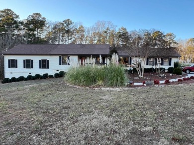 Spacious lake home on 2.9 acre lot with boat dock in place and for sale on GolfHomes.com