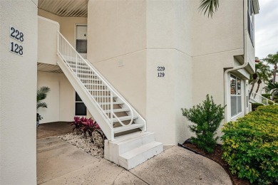 This ground-floor condo with 2 bedrooms and 2 bathrooms embodies on Isla Del Sol Yacht and Country Club in Florida - for sale on GolfHomes.com, golf home, golf lot