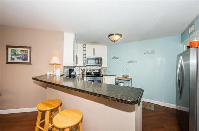 This ground-floor condo with 2 bedrooms and 2 bathrooms embodies on Isla Del Sol Yacht and Country Club in Florida - for sale on GolfHomes.com, golf home, golf lot