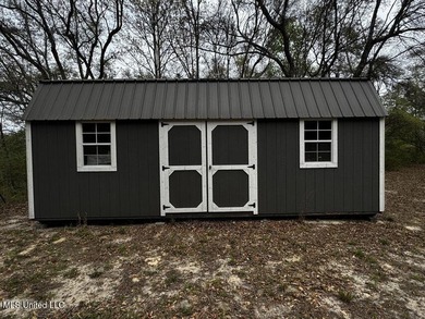 Nestled on two spacious lots, this charming 3-bedroom, 2-bath on The Kings Arrow Ranch in Mississippi - for sale on GolfHomes.com, golf home, golf lot