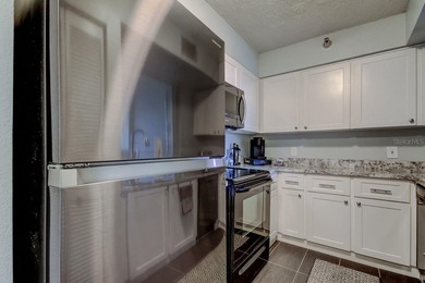 Discover this light-filled and spacious end-unit condo in the on Feather Sound Country Club in Florida - for sale on GolfHomes.com, golf home, golf lot