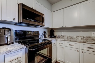 Discover this light-filled and spacious end-unit condo in the on Feather Sound Country Club in Florida - for sale on GolfHomes.com, golf home, golf lot