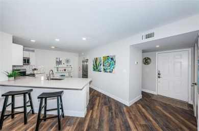 Come check out this desirable first floor furnished designer on Isla Del Sol Yacht and Country Club in Florida - for sale on GolfHomes.com, golf home, golf lot