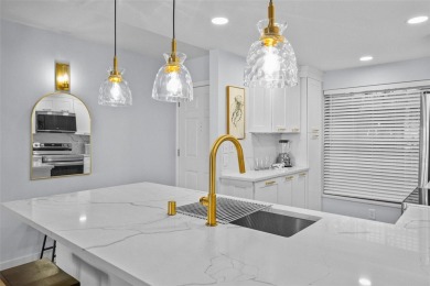 Casa Del Mar Villa.  With stunning water views, this first floor on Isla Del Sol Yacht and Country Club in Florida - for sale on GolfHomes.com, golf home, golf lot