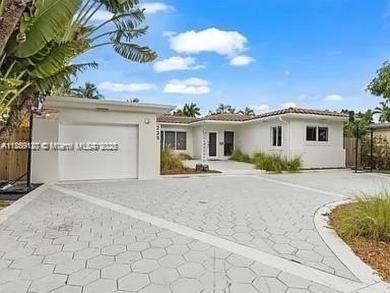 Beautiful light and bright pool home in a gated residential golf on Normandy Shores Golf Course in Florida - for sale on GolfHomes.com, golf home, golf lot