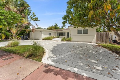 Beautiful light and bright pool home in a gated residential golf on Normandy Shores Golf Course in Florida - for sale on GolfHomes.com, golf home, golf lot
